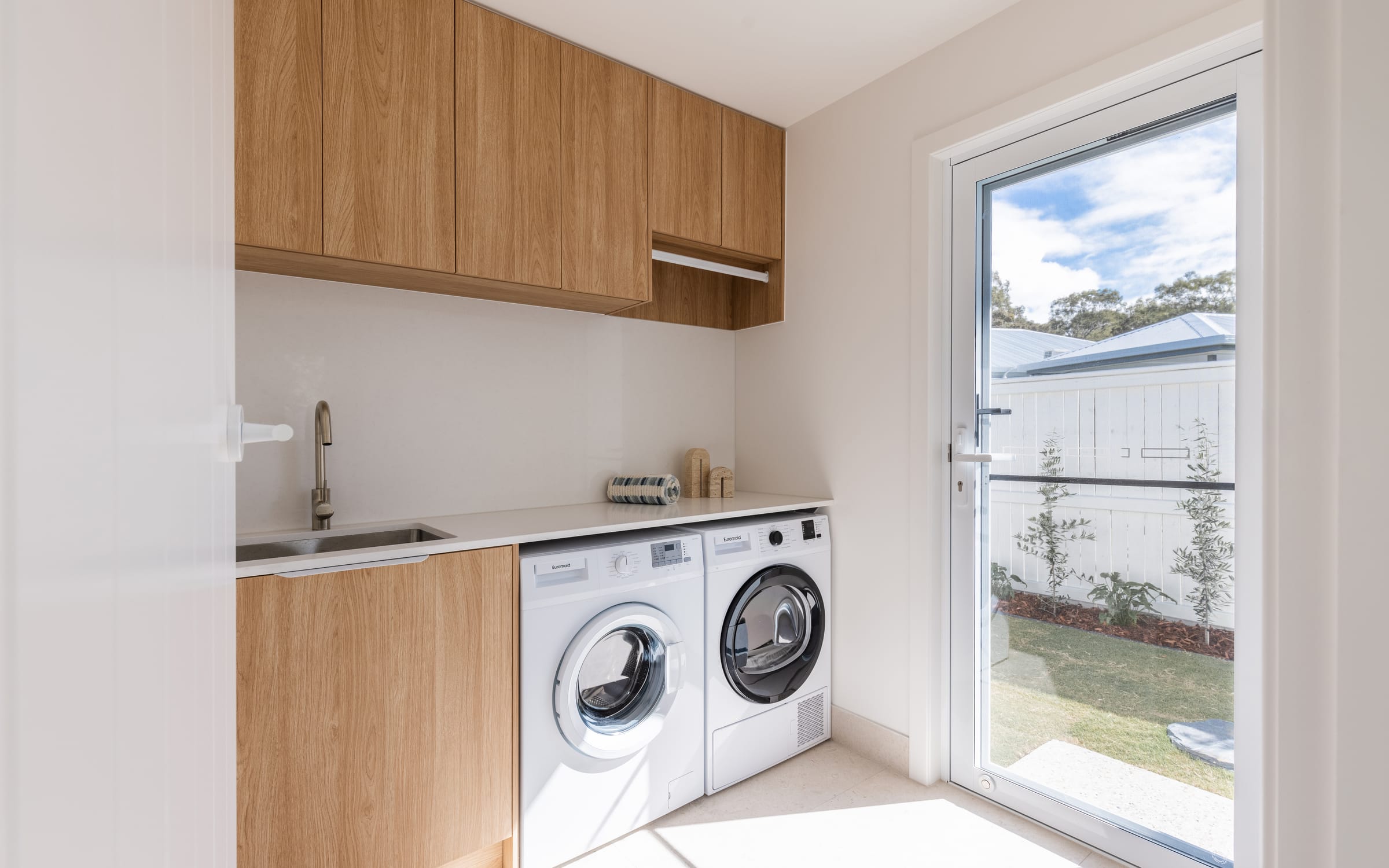 Custom oak laundry with a garden door on the Gold Coast
