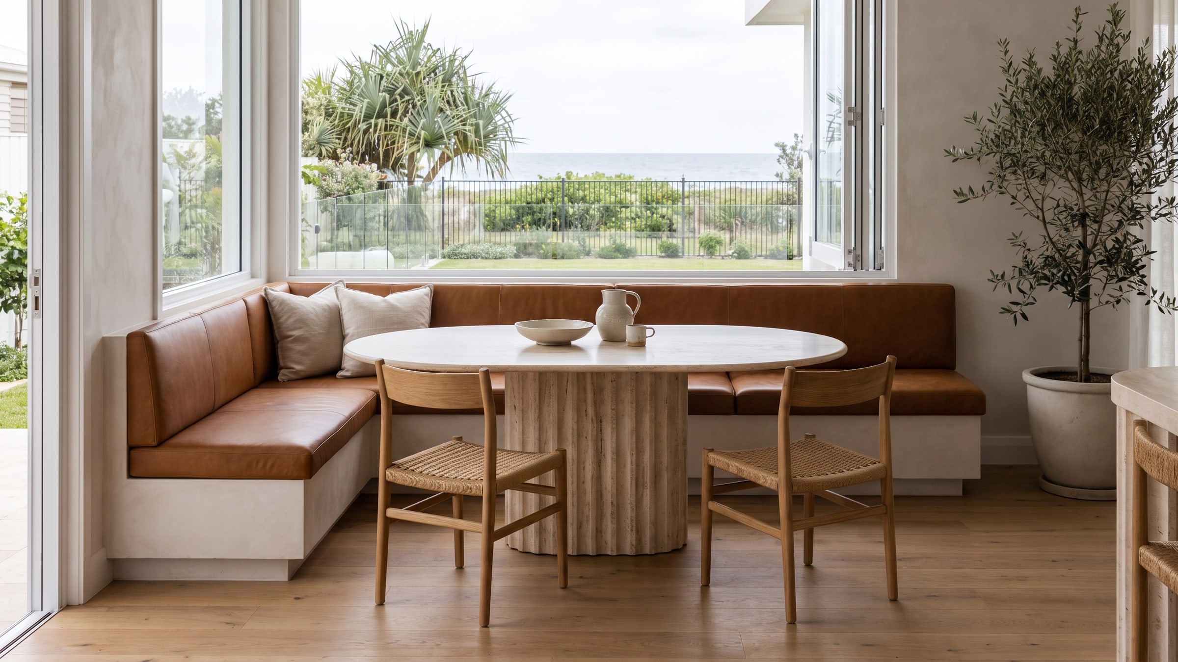 Custom built-in dining banquette with a pedestal table on the Gold Coast