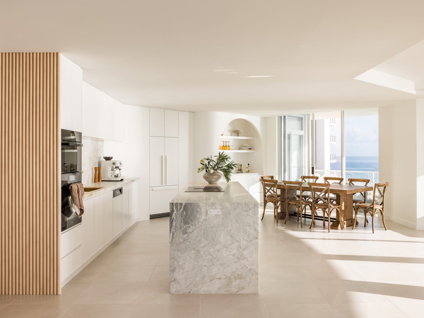 Beachfront apartment kitchen with a stone island and ocean views - 4D Cabinetry kitchen renovations