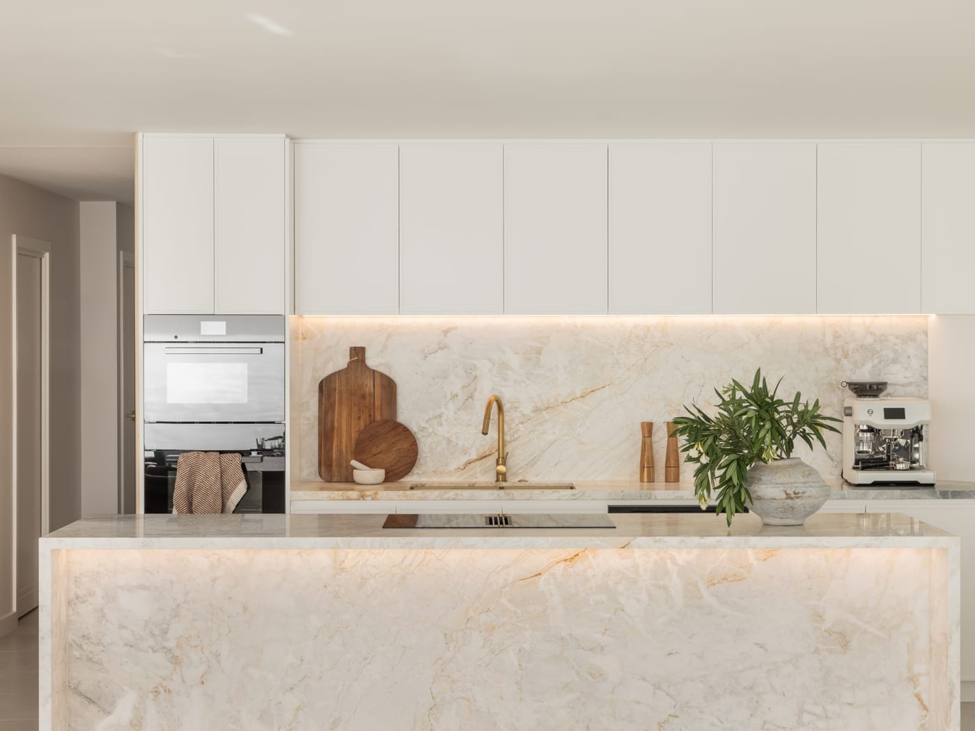 Contemporary white kitchen with a backlit stone island - 4D Cabinetry kitchen renovations