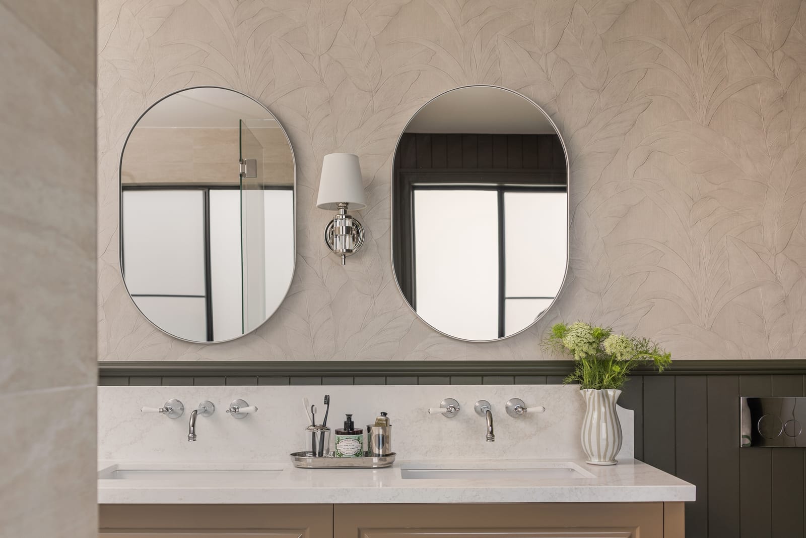 Custom double vanity with oval mirrors and a stone top